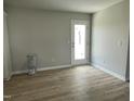Bright dining area featuring laminate flooring and a glass patio door for easy access to the backyard at 110 Coharie Dr, Lillington, NC 27546
