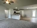 Open-concept kitchen and living area featuring new appliances and stylish wood-look flooring at 110 Coharie Dr, Lillington, NC 27546