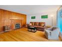 Inviting living room with a fireplace, wood paneling and hardwood floors at 112 Noble St, Chapel Hill, NC 27516