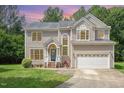 Charming two-story home with manicured lawn, attached garage, and a welcoming teal front door at sunset at 113 Paladin Place, Cary, NC 27513