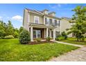 Classic home exterior featuring a covered porch with white columns and meticulously maintained landscaping at 1144 Survada Ln, Morrisville, NC 27560