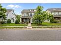 Traditional two-story home with manicured front lawn and landscaping, including a charming tree in the yard at 1144 Survada Ln, Morrisville, NC 27560