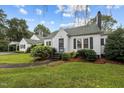 A charming home with lush landscaping and dark shutters at 1146 Rogers Rd, Graham, NC 27253