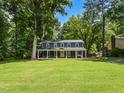Exterior of charming home with well-maintained lawn and mature trees in a desirable neighborhood setting at 1215 Brookgreen Dr, Cary, NC 27511