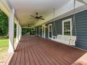 Spacious porch with a swing and ceiling fans, providing a comfortable outdoor space for relaxing and entertaining at 1215 Brookgreen Dr, Cary, NC 27511
