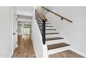 Bright stairway featuring modern railing and hardwood flooring leading to upper level at 129 Assembly Ct, Cary, NC 27511