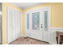 Bright entryway featuring decorative glass front door, closet for storage, and neutral tile flooring at 1413 Roy Averette Dr, Raleigh, NC 27603
