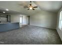Spacious living room featuring plush carpeting, a ceiling fan, and an open concept design at 148 Coharie Dr, Lillington, NC 27546