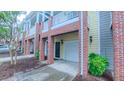 Exterior brick and siding townhome with individual garages at 151 Braeside Ct, Cary, NC 27519