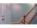 Light and bright staircase with wooden handrail and white risers at 151 Braeside Ct, Cary, NC 27519