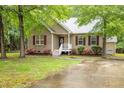 Charming home's exterior boasts colorful flowers, lush lawn, and a welcoming front porch at 1510 Bungalow Ave, Durham, NC 27703