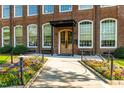 Beautiful brick building with large windows and a lovely flower bed along the sidewalk at 1535 Caraleigh Mills Ct # 111, Raleigh, NC 27603