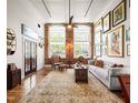 Charming living room with hardwood floors, exposed brick wall, and plenty of natural light at 1535 Caraleigh Mills Ct # 111, Raleigh, NC 27603
