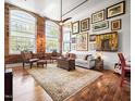Spacious living room featuring hardwood floors, high ceilings, and an abundance of natural light at 1535 Caraleigh Mills Ct # 111, Raleigh, NC 27603