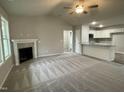 Open-concept living room featuring a fireplace and seamless flow into the kitchen at 170 Starry Sky Dr, Benson, NC 27504