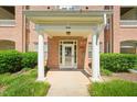 Building entrance featuring stately columns, unit number display and brick facade at 1700 Tiffany Bay Ct # 303, Raleigh, NC 27609