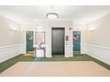 Well-lit lobby featuring neutral walls, green carpet, table, mirror and decor at 1700 Tiffany Bay Ct # 303, Raleigh, NC 27609