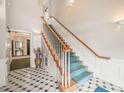Elegant stairwell with green carpet, white trim and decorative tile flooring at 1700 Tiffany Bay Ct # 303, Raleigh, NC 27609