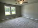 Spacious bedroom with plush carpeting, a ceiling fan, and bright natural light at 186 Coharie Dr, Lillington, NC 27546