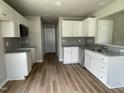 Well-lit kitchen featuring bright white cabinets, granite countertops, and stainless appliances at 186 Coharie Dr, Lillington, NC 27546