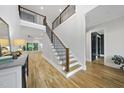 Grand foyer featuring a staircase with iron balusters, hardwood floors, and soaring ceilings at 2040 Pleasant Forest Way, Wake Forest, NC 27587