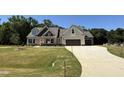 Newly constructed two-story home with an attached two car garage and a long driveway at 217 Busterfield Ct, Benson, NC 27504
