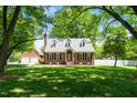 Brick house with black shutters, a well-manicured lawn, and a two-car garage for convenient parking at 2417 Ridgeford Ct, Fuquay Varina, NC 27526