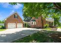 Spacious driveway leading to a brick home with an attached garage and lush landscaping at 2417 Ridgeford Ct, Fuquay Varina, NC 27526