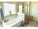 Beautiful bathroom featuring a soaking tub and glass-enclosed shower with natural light at 2511 Kestrel Heights Ct Ct, Durham, NC 27703