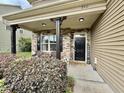 Inviting front porch with stone accents, black door, and manicured landscaping for curb appeal at 2511 Kestrel Heights Ct Ct, Durham, NC 27703