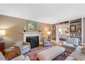 Elegant living room featuring a fireplace, hardwood floors, and built-in bookshelves at 2608 York Rd, Raleigh, NC 27608