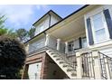 Exterior staircase leading to a balcony on this home's inviting façade at 2800 Charleston Oaks Dr, Raleigh, NC 27614