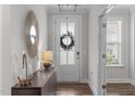 Inviting entryway with stylish console table and statement mirror at 2915 Winter Crop Way, Apex, NC 27502