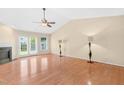Bright living room featuring hardwood floors, fireplace, ceiling fan, and a sliding glass door at 3027 Maple Ave # A-1, Burlington, NC 27215