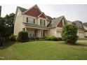 Charming two-story home with a well-manicured lawn and beautiful landscaping at 309 Forest Haven Drive Dr, Holly Springs, NC 27540
