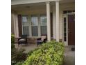 Inviting front porch with comfortable seating, columns, and decorative landscaping at 309 Forest Haven Drive Dr, Holly Springs, NC 27540