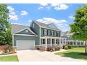 Charming two-story home with a welcoming front porch, landscaped yard, and attached garage provides curb appeal at 309 Larkhaven Pl, Apex, NC 27539