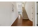 Foyer featuring hardwood flooring, a staircase, and an open view to the home's interior at 309 Plank Bridge Way, Morrisville, NC 27560
