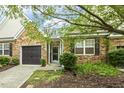 Home with stone facade, a two-car garage, and mature landscaping for curb appeal at 309 Plank Bridge Way, Morrisville, NC 27560