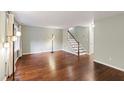 Open-concept living room featuring hardwood floors, staircase, and neutral walls at 310 Bay Dr, Cary, NC 27511