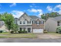 Charming two-story home with attached garage, well-maintained lawn, and inviting curb appeal at 3449 S Beaver Ln, Raleigh, NC 27604