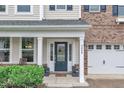 Inviting entrance with a dark blue front door, white trim, and charming landscaping at 3449 S Beaver Ln, Raleigh, NC 27604