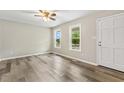 Bright living room with wood-look flooring and views of the front yard through the windows at 366 E Smithfield St, Angier, NC 27501