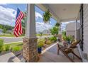 Charming front porch with stone pillars, hanging ferns, and comfortable seating, perfect for enjoying the outdoors at 40 Bourne Dr, Franklinton, NC 27525