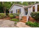 Inviting home entrance with brick steps, white railings, and neat landscaping at 4004 Bamburgh Ln, Apex, NC 27539