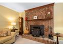 Living room brick fireplace with vintage stove and wooden mantle at 4004 Bamburgh Ln, Apex, NC 27539