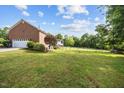 The lush, green backyard offers space for outdoor enjoyment and recreation at 4024 Rural Retreat Rd, Burlington, NC 27215