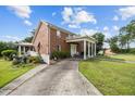 Brick home featuring a covered front porch with stately white columns at 4024 Rural Retreat Rd, Burlington, NC 27215