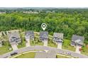 Aerial view of homes in a neighborhood with lush green trees and beautifully landscaped yards at 421 Gilpin Way, Cary, NC 27519