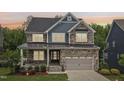 Beautiful two-story home with a stone and siding facade, well-maintained lawn, and inviting front porch at 421 Gilpin Way, Cary, NC 27519
